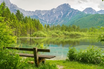 Bench near Alps mountains and lake in Almsee in Austria.