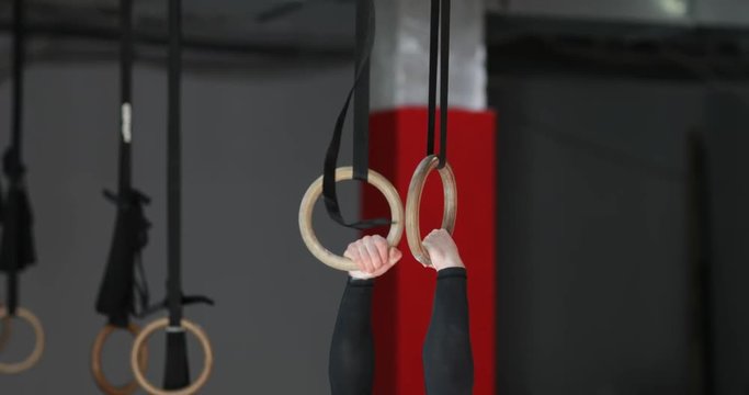 Young Man Exercising On Gymnastic Rings During Workout Training At Gym Male Athlete Fitness