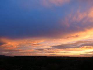 Vibrant orange sunset with clouds.