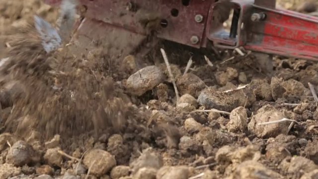 Plowing the soil with a motoblock in slow motion