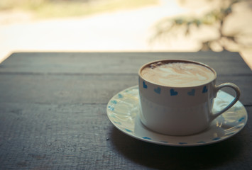cup of coffee on wood table