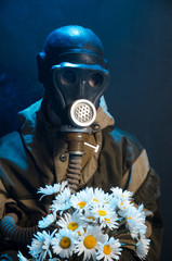 the photo of girl in gas mask on grey background c daisies