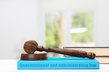 Wooden gavel and books on wooden table