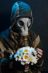 the photo of girl in gas mask on grey background c daisies
