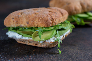 Green sandwich with soft cheese, avocado and fresh cucumber