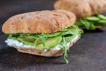 Green sandwich with soft cheese, avocado and fresh cucumber