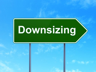 Business concept: Downsizing on road sign background