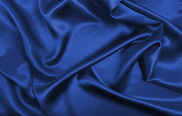 Smooth elegant blue silk or satin luxury cloth texture as abstract background. Luxurious background design
