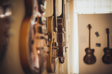 Retro bass guitar in vintage style on shelves in a musical instrument store