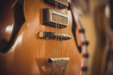 Retro bass guitar in vintage style on shelves in a musical instrument store