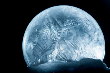 Naklejka na ściany i meble Frozen bubble close-up, winter holidays background,