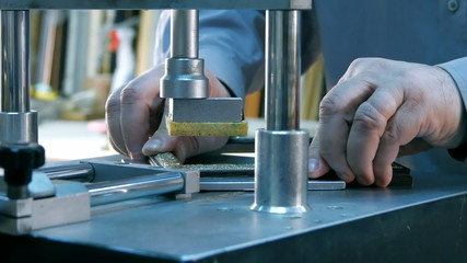 Professional framer hand holding frame angle, working on machine