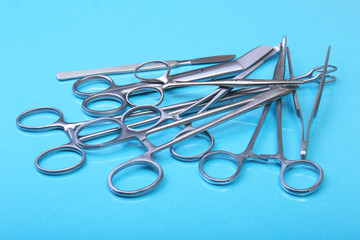 Close Up Surgical instruments and tools on blue mirror background. Selective focus.