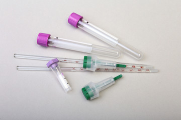 Set of laboratory supplies for blood test. Petri dish, scarifier, Spectrophotometer cuvettes, blood test-tube. Selective focus.