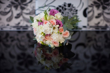 bridal bouquet lies on a black table