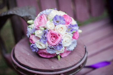 wedding bouquet lies on a wooden table