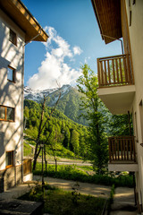Mountain Village in the summer. Rosa Khutor, Sochi. Sun view of the plateau, hotel complexes and mountains.