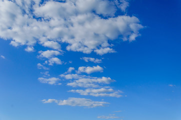 Naklejka na ściany i meble White clouds in deep blue sky