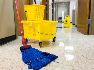 Wet floor with mop bucket and wet floor sign - 158577737