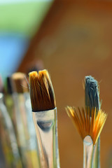 Close up of paint brushes outdoors. Selective focus vertical image