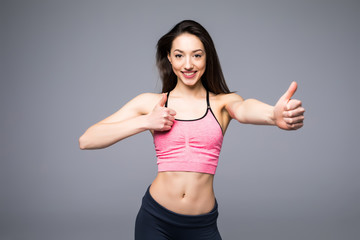 Fototapeta na wymiar Beautiful fitness woman showing thumb up on white background