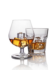 Two glasses of strong alcoholic drink scotch whiskey with ice cube