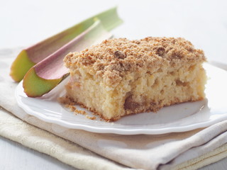 Piece of coffeecake isolated on white. Biscuit with strawberry, rhubarb and apples. Homemade crumble pie with streusel topping. Isolated. Selective focus.