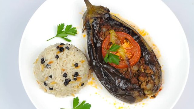 Turkish cuisine. Karniyarik and rice pilaf with black corinth raisin. Eggplant stuffed ground meat. 1920x1080p HD Video