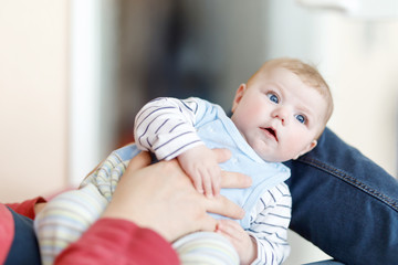 Happy proud young father with newborn baby daughter, family portrait togehter