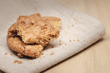 Pastry biscuits on linen napkin on wooden table
