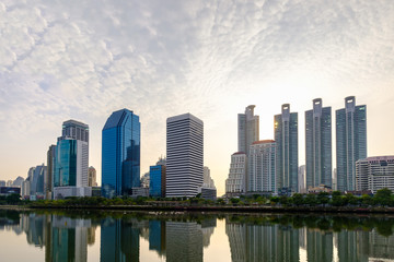 Fototapeta na wymiar Bangkok city downtown at sunrise with reflection of skyline