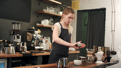 Hands of barista adding salt caramel in coffee