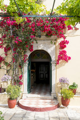 Fototapeta na wymiar Entrance to the church in Monastery of of Virgin Mary in Paleokastritsa, Corfu island in Greece.