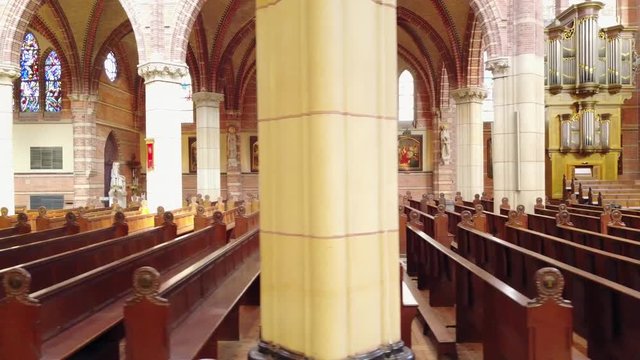 Slider shot along the benches of a catholic church