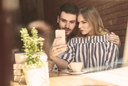 Young couple using mobile device