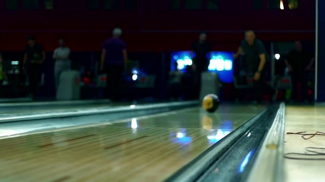 Bowling ball on wooden bowling alley slow motion.
