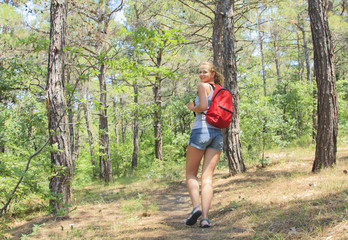 Beautiful young girl with a backpack in the tourism campaign