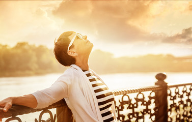 Portrait of a happy attractive mature senior woman 50 years old at sunset