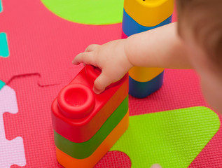 Toddler plays with building block