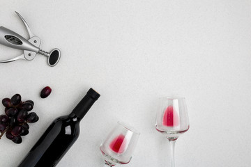 Bottle of red wine with glasses on white background top view mock-up