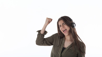 Woman with headphones listening anf enjoing music. Girl with headphones against white background isolated.
