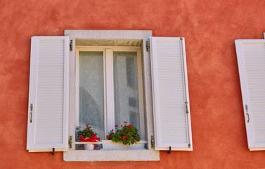 Open white woodenwindow on the Red Wall