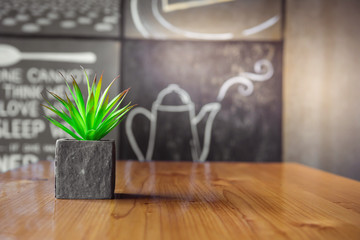 A vase placed on the table. Wooden table.