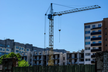 High construction crane against blue sky