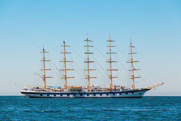Fototapeta na wymiar The large sailing ship with five masts anchored in the open sea near old city Piran, Slovenia