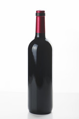 Clear bottle forwine with red top isolated on white.