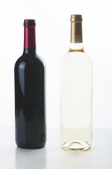Vertical studio shot of two unlabeled bottles for red and white wine.