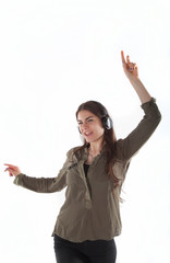 Woman with headphones listening and enjoing music. Girl with headphones dancing against white background isolated.
