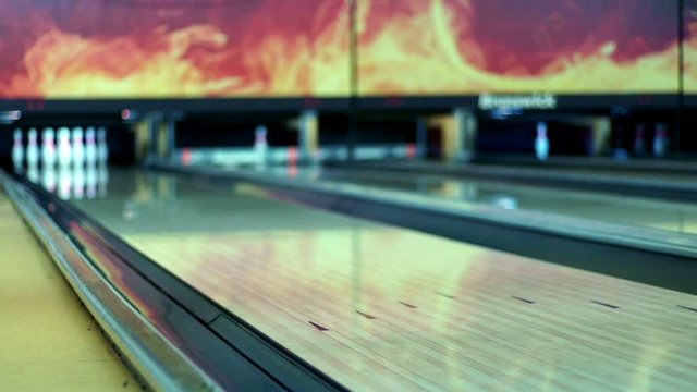 Bowling ball on wooden bowling alley slow motion