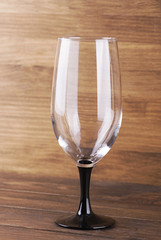 Glass of wine on wooden table. Vertical studio shot.